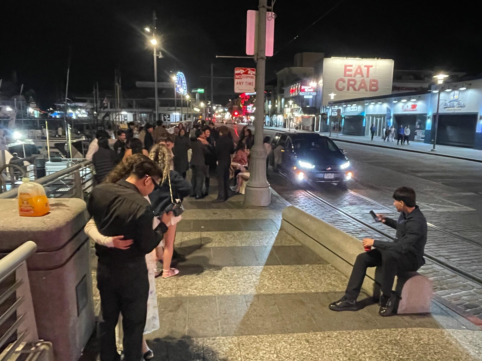 Sunday evening at SF Fisherman's Wharf — retail dark, the boat dock alive